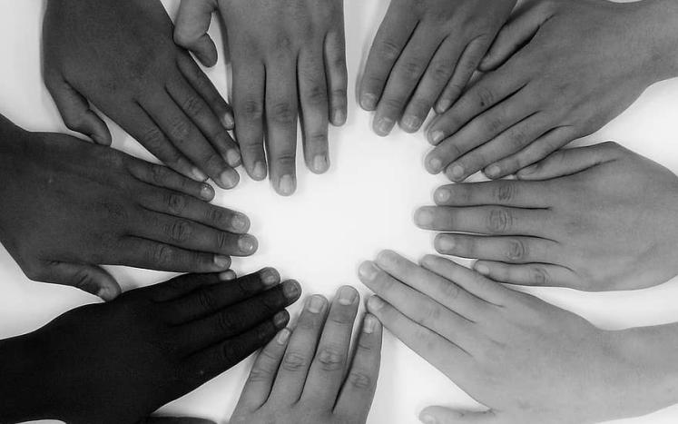 Hands of all colors and skin tones together with love